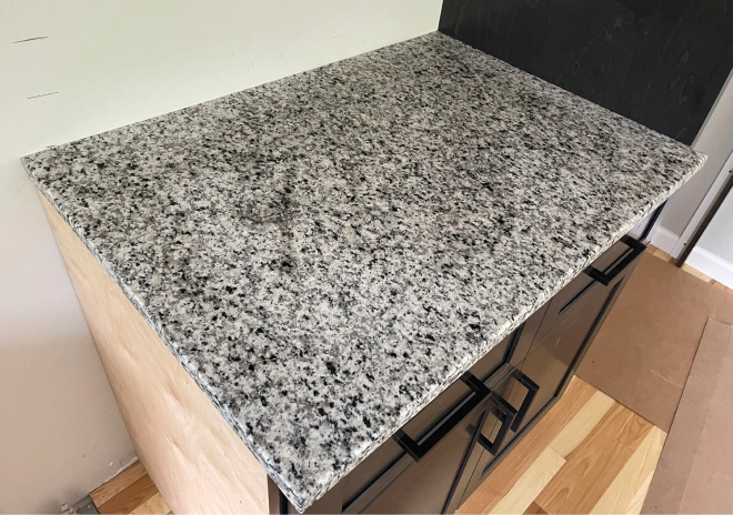 a recently installed custom cabinet with countertop slab